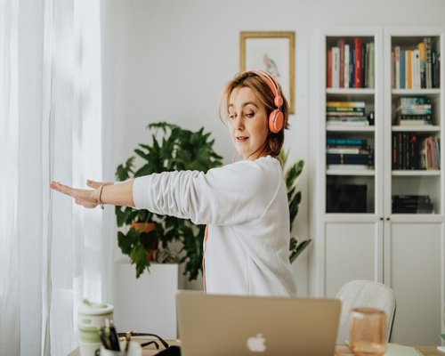 Person doing light wrist stretches at their desk